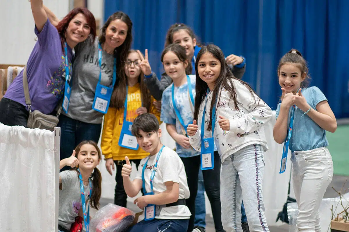 students smiling for a photo during a Destination Imagination tournament