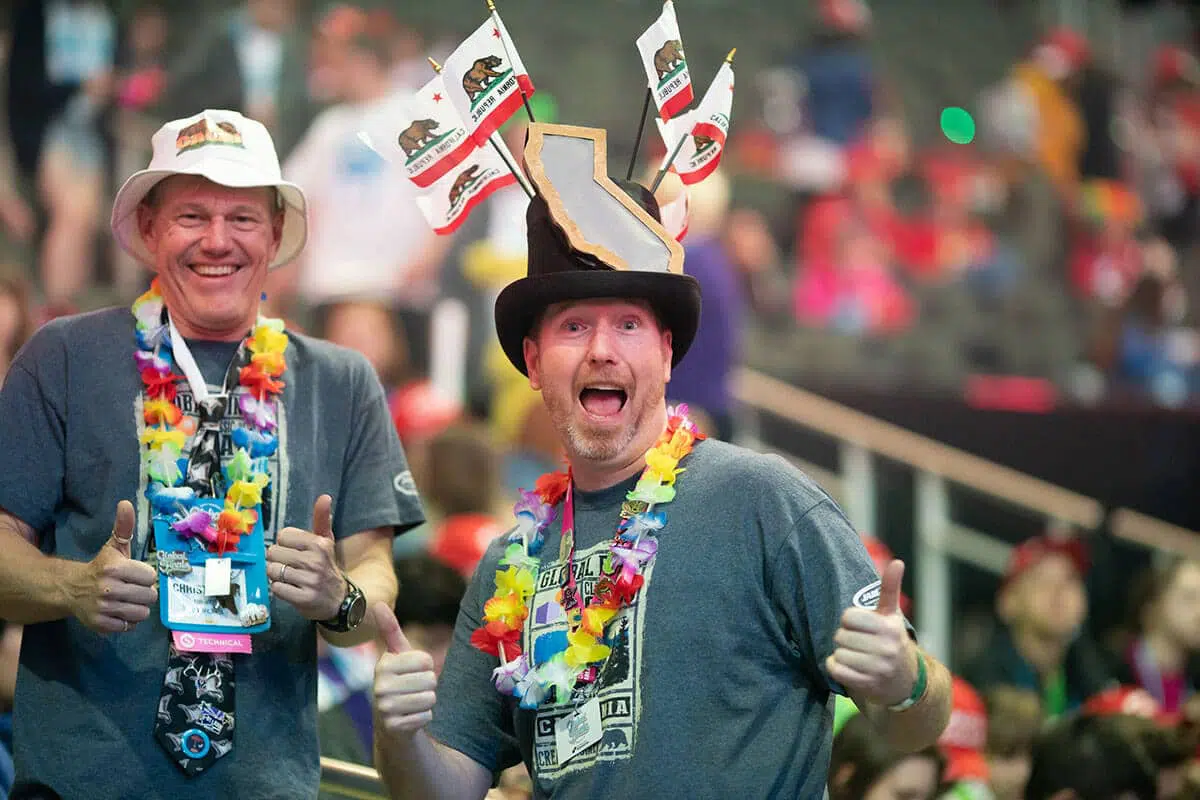 Team managers smiling for a photo during a Destination Imagination tournament