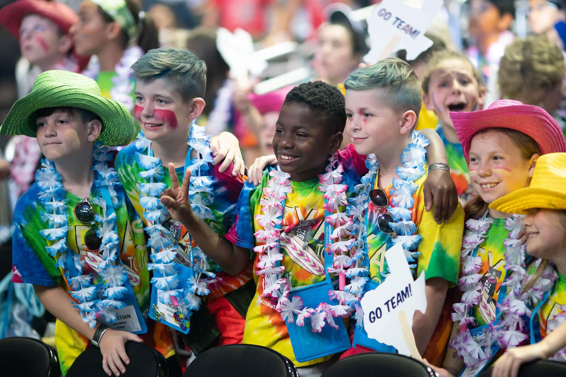 Group of students smiling and posing for a photo during a Destination Imagination tournament