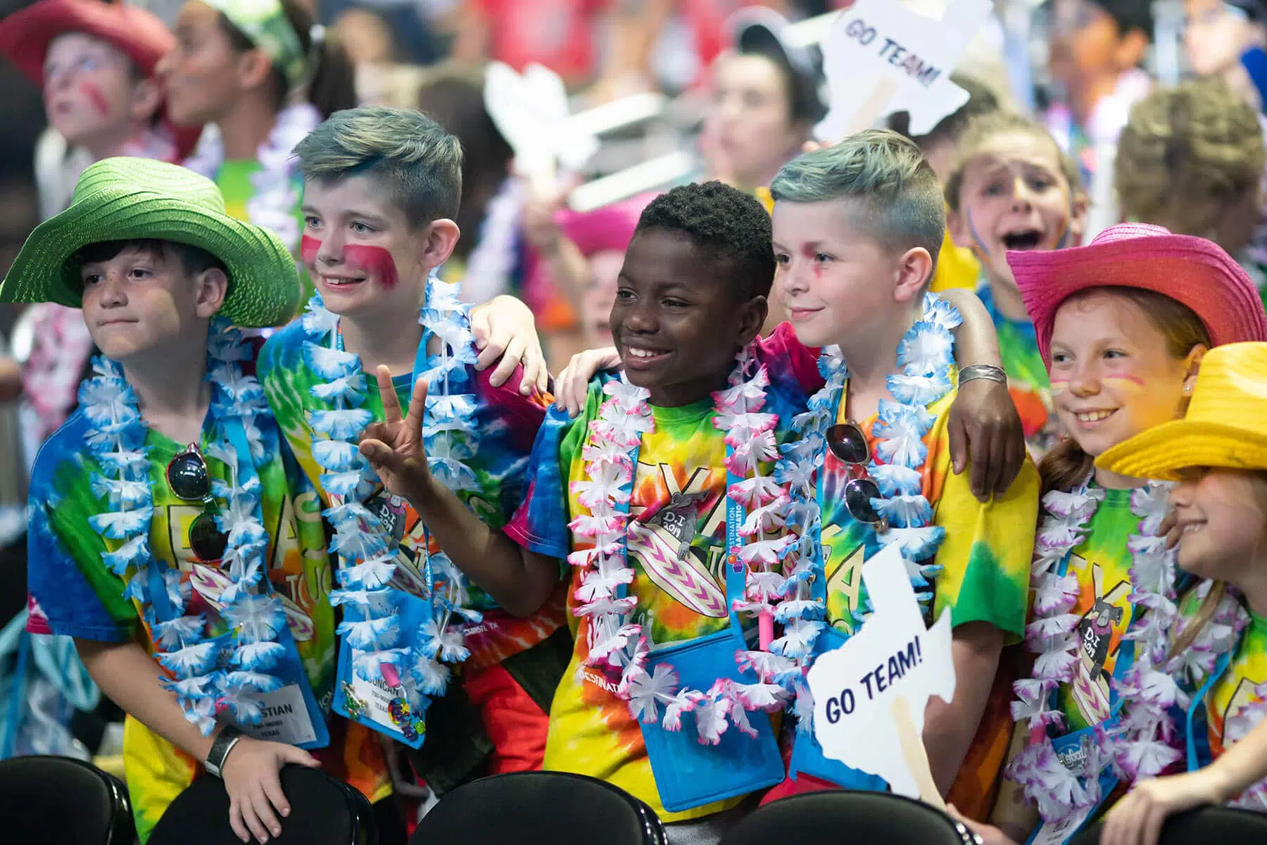 Group of students smiling and posing for a photo during a Destination Imagination tournament